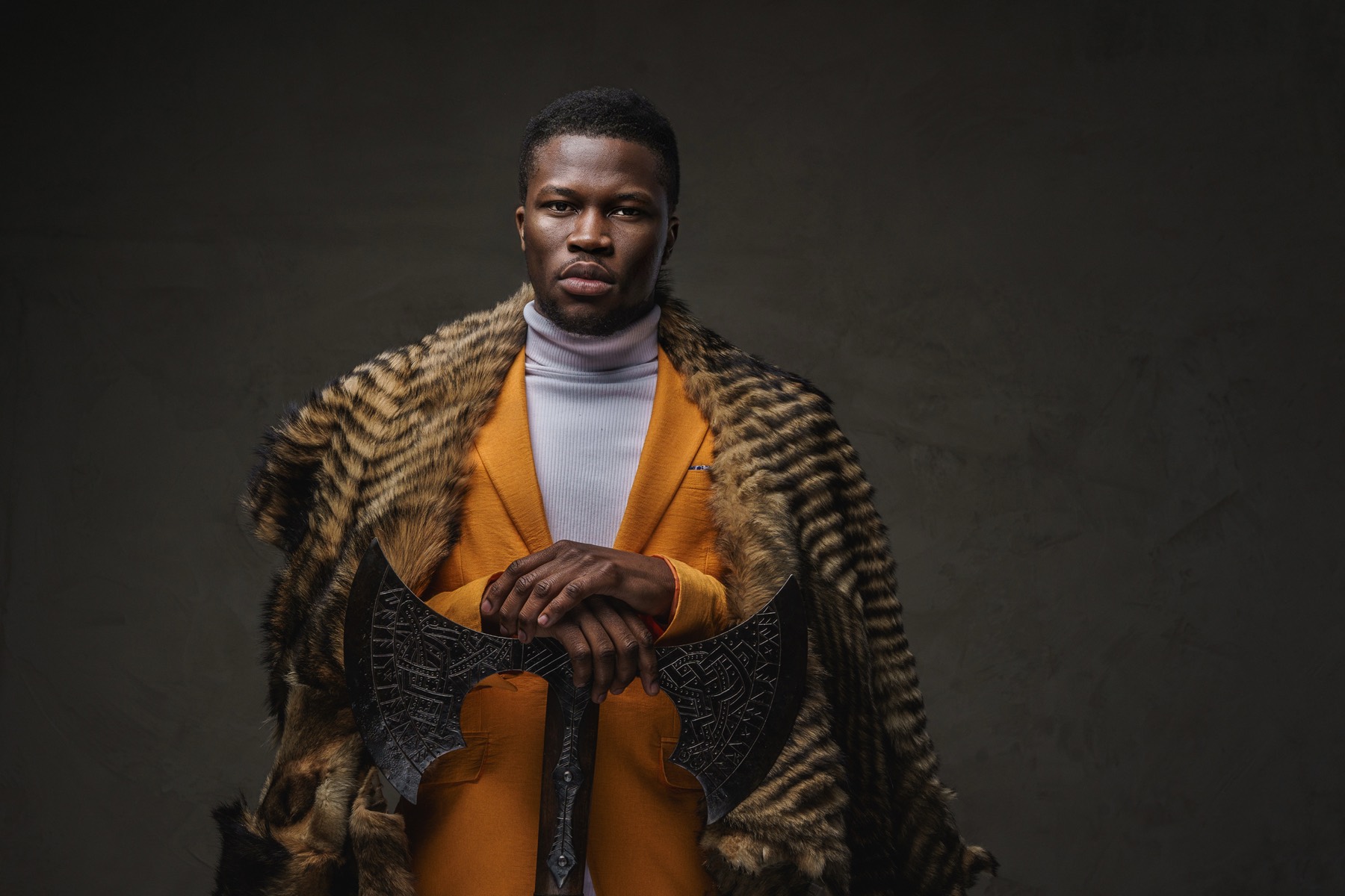 Model wearing a textured statement coat over an orange suit
